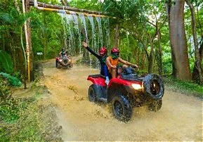 Aventurero recorriendo senderos embarrados en un ATV durante el tour River Park ATV Adventure en Puerto Vallarta, rodeado de naturaleza y adrenalina.